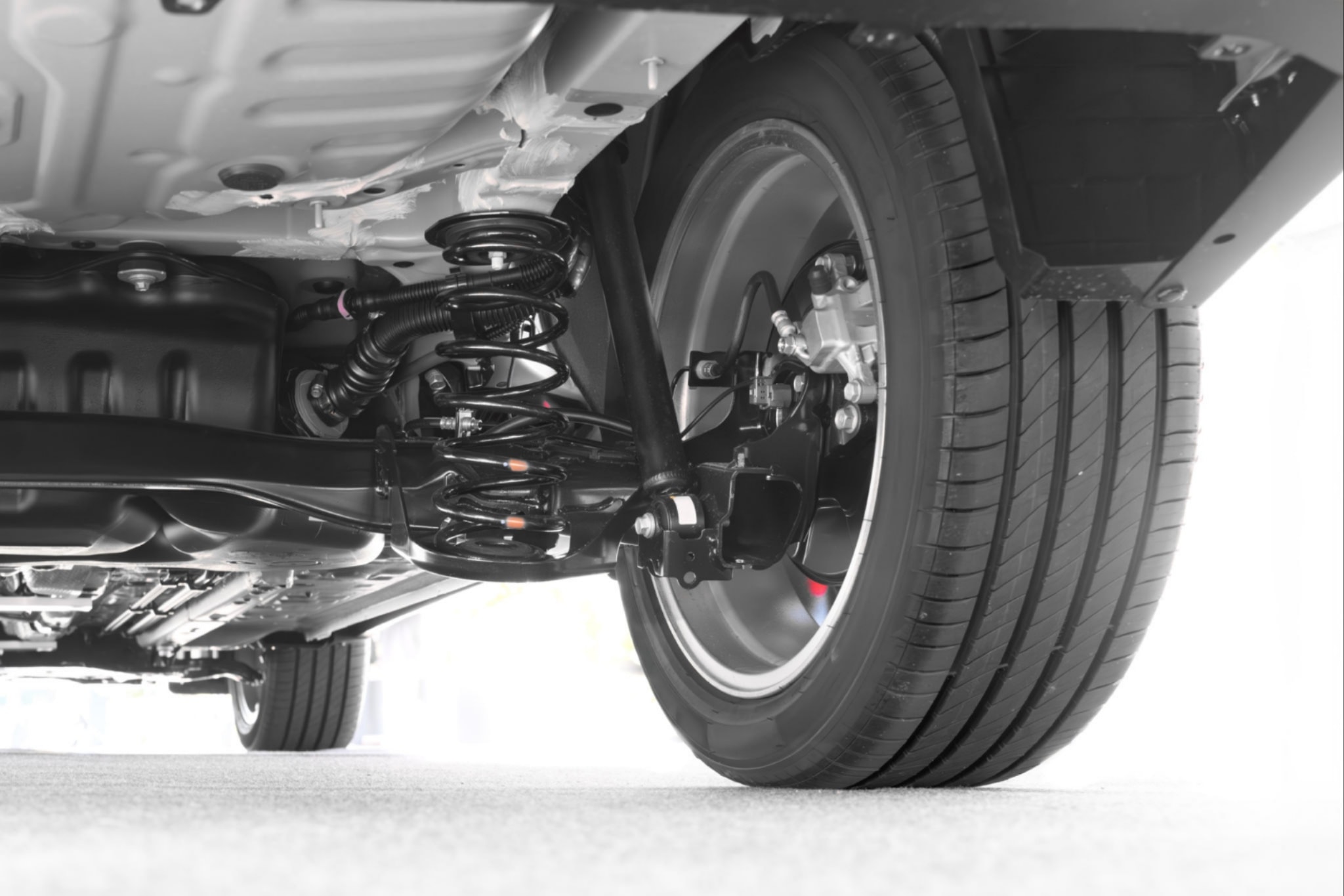 Mechanic inspecting suspension strut